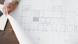 cropped view of african american architect near blueprint and smartphone with blank screen, banner