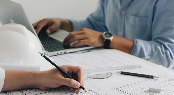 Engineer constuction and interior team dissussing in the office. and angineer working drawing on blueprint meeting for project working with a partner on model building plans at table in a modern office.construction concept.  